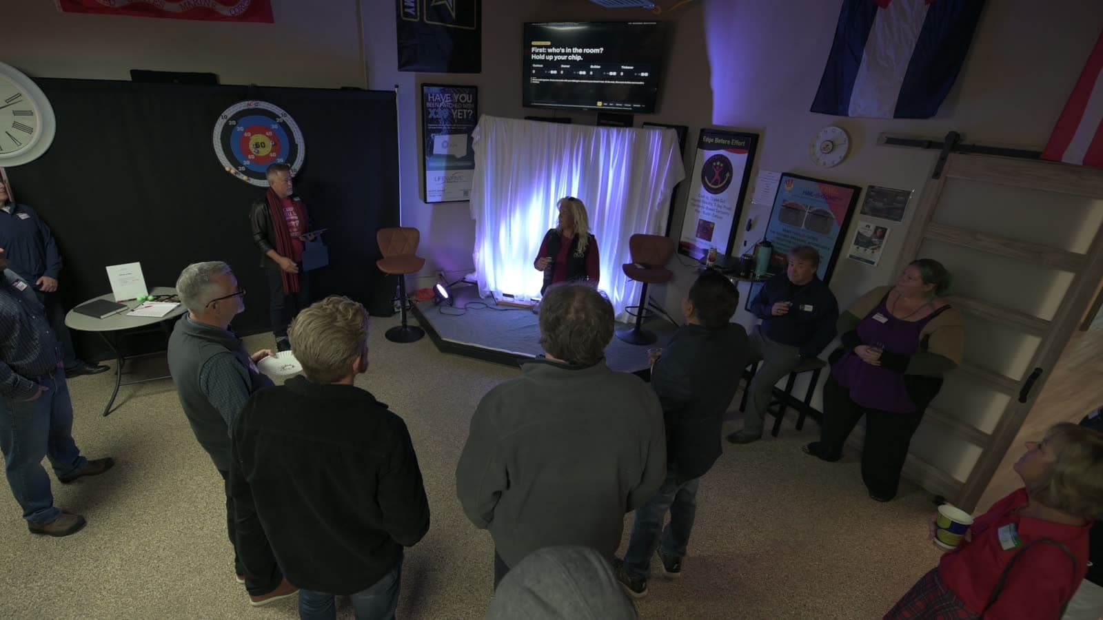 Wide view of the room as a speaker addresses guests