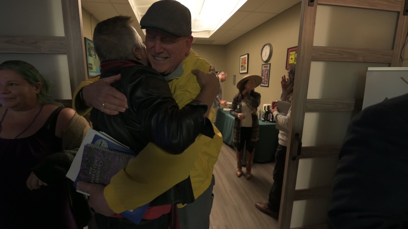 Two attendees hug hello