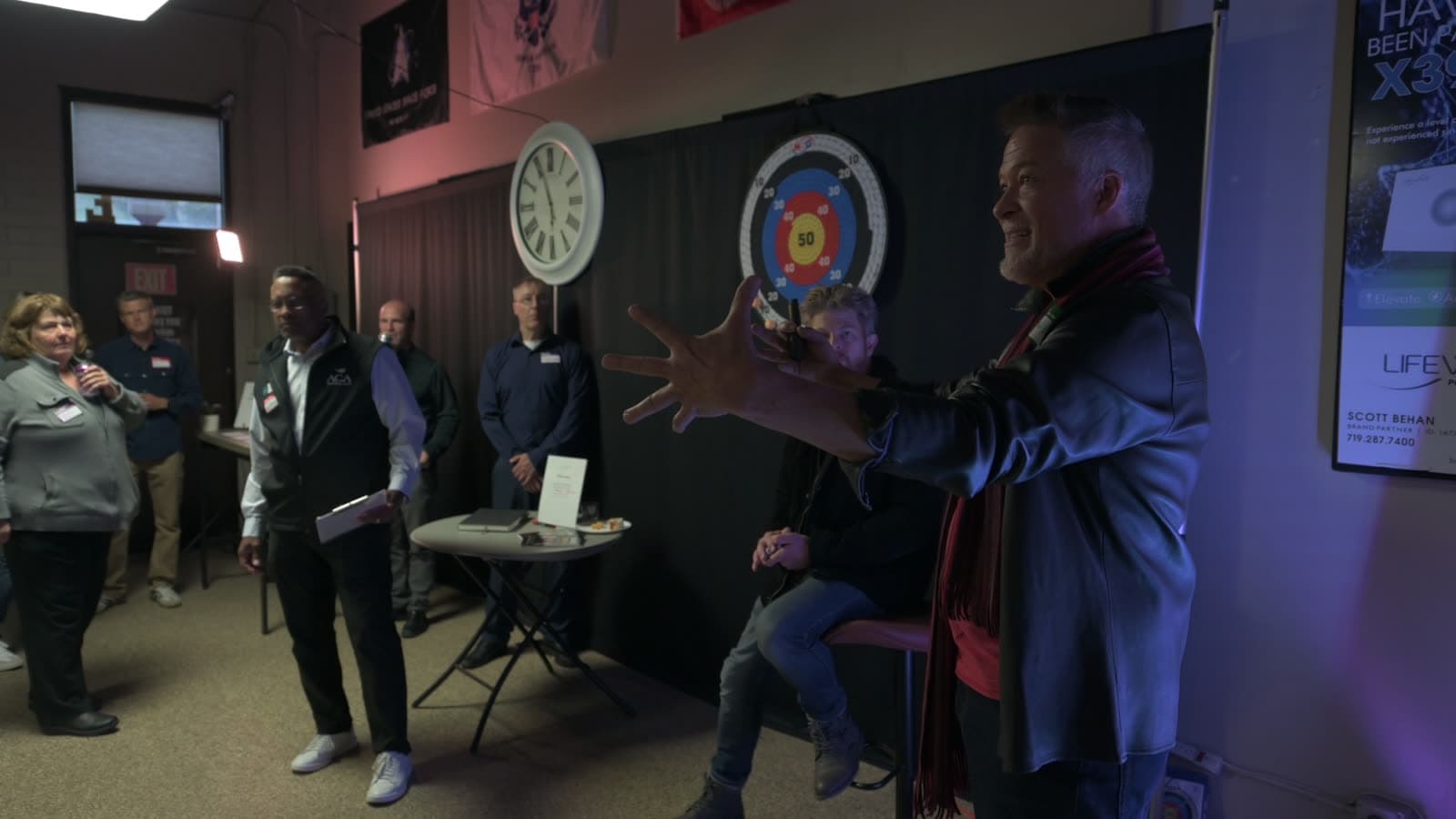 A speaker gestures while talking with the room